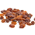 brown raisins on a white background